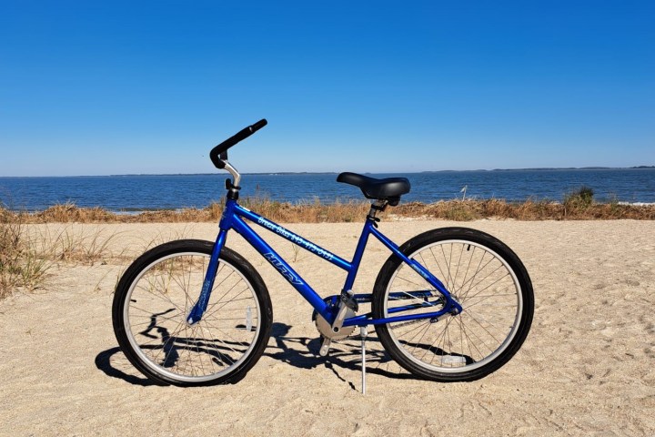 a bicycle parked on the side of a lake